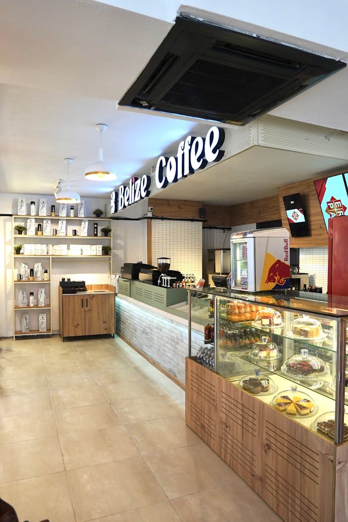 Bright interior of a cozy coffee shop with pastries and coffee display.