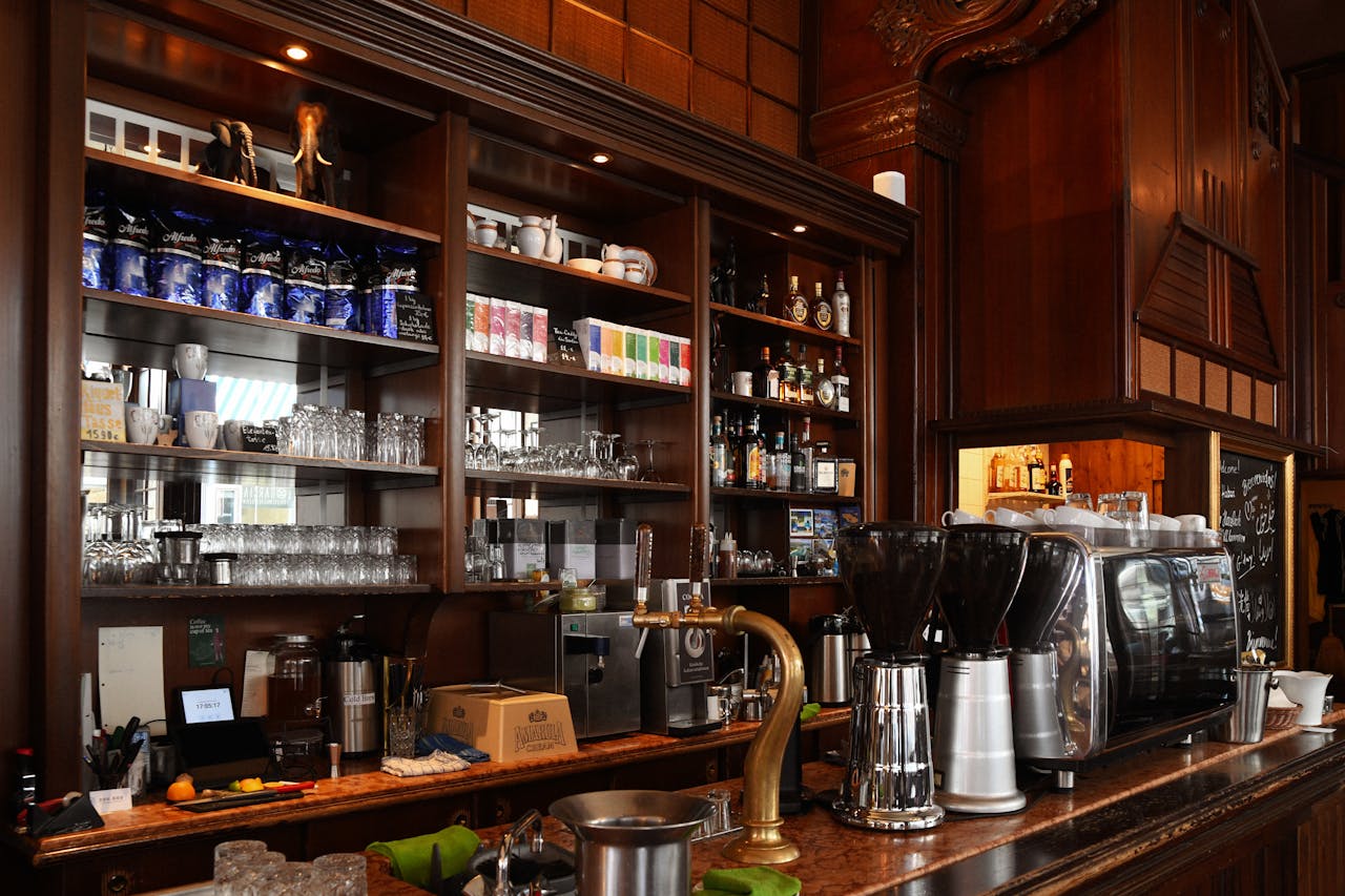 about-01 Elegant coffee shop counter displaying an espresso machine and various drinks.